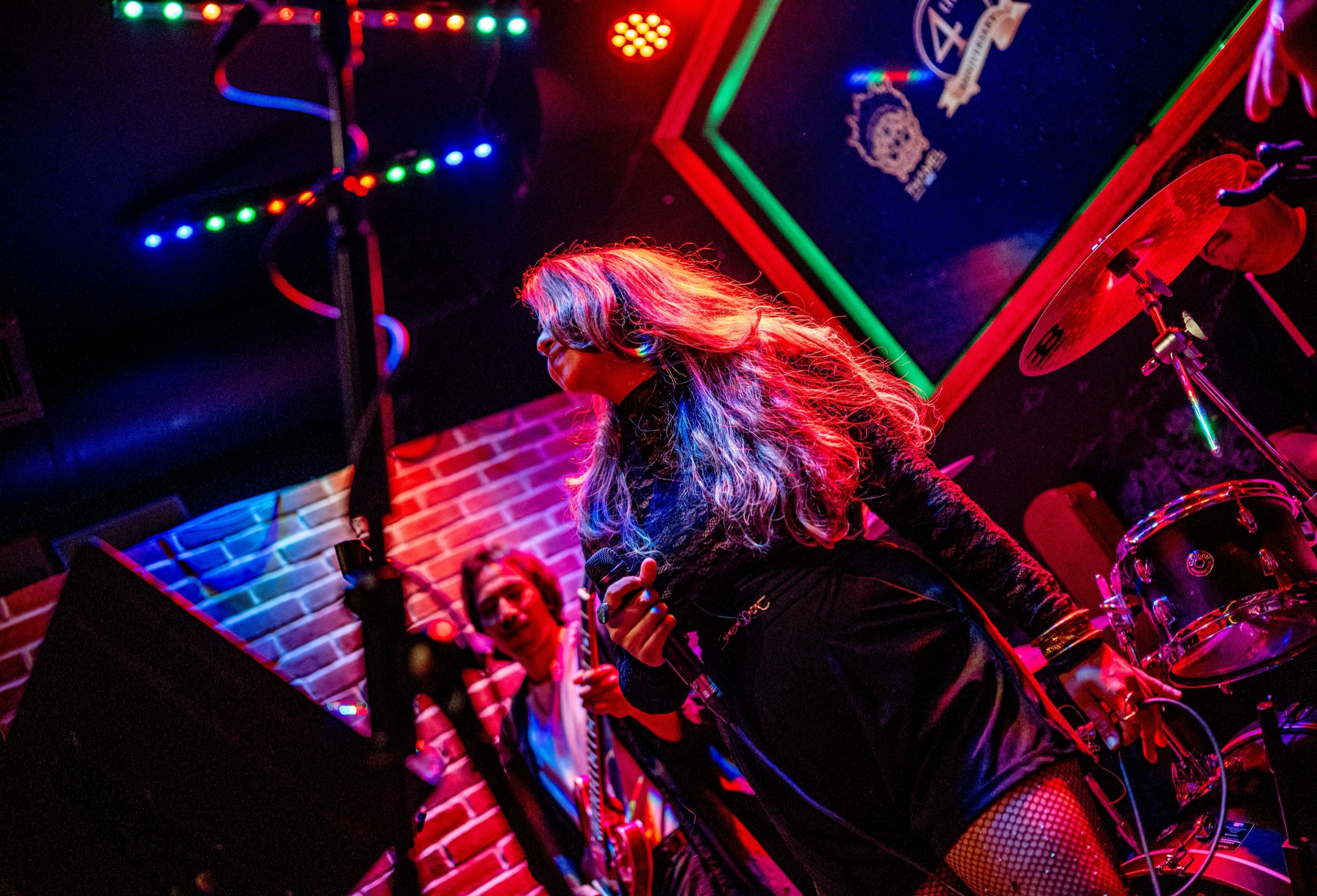 Rebecca on stage with neon lights